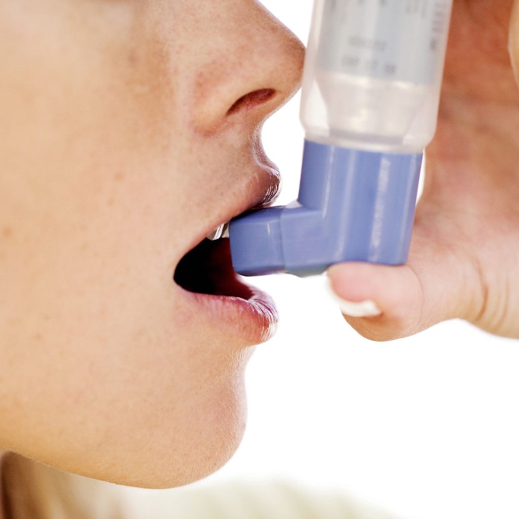 Woman Using an Inhaler