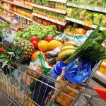 Full shopping cart with fruits, vegetables, food in supermarket