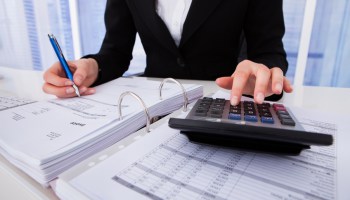 Businesswoman Calculating Tax