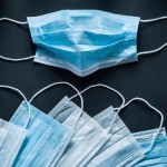 Disposable respiratory medical masks on black background
