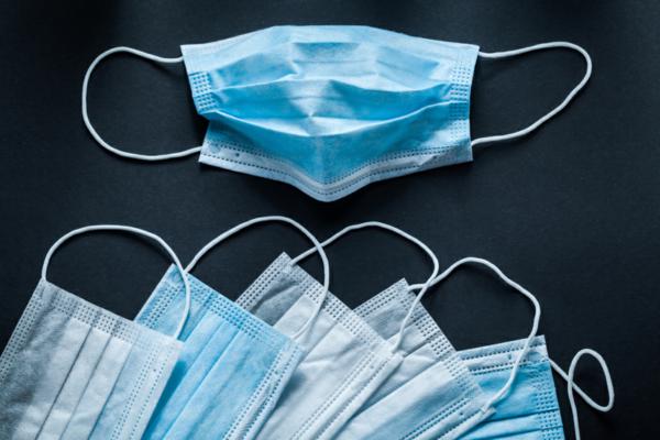 Disposable respiratory medical masks on black background