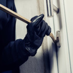 Burglar breaking in to a house door